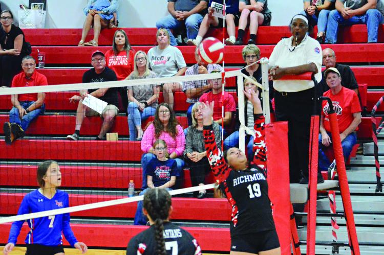 TIARA SMITH (No. 19) has the attention of spectators and players alike as she attempts a set shot Oct. 5 in the Richmond High School gym.