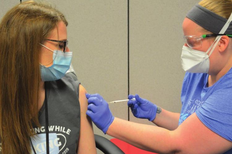 VACCINE goes into Clay County Health Center Program Manager Corrie Courtney’s arm.