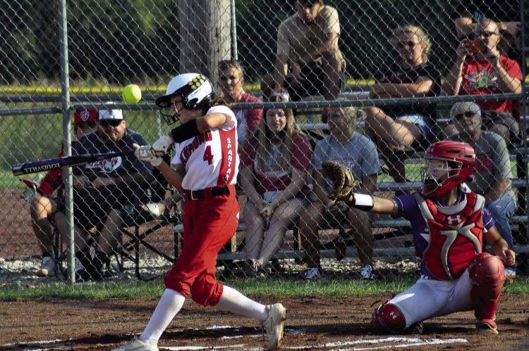 SYDNEY APPLEBERRY, shown swinging at a pitch in 2021, is taking on a different role on Richmond’s varsity softball team for her senior season because of a torn ACL and meniscus. SHAWN RONEY | Staff
