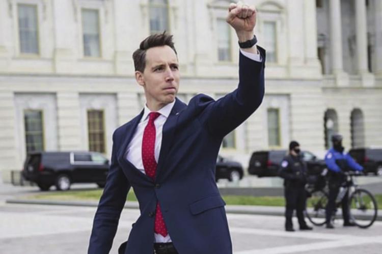 U.S. SEN. Josh Hawley raises his fist in support of the crowd that gathers in protest of the presidential election outcome, which Hawley questions. FRANCIS CHUNG | E&amp;E News/Politico