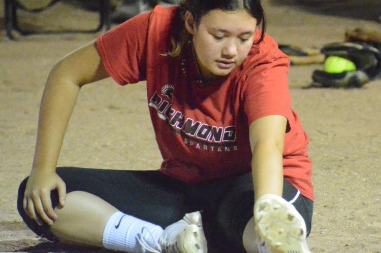 SOPHOMORE ALEANA McFEE stretches on Aug. 8 at Southview Park in Richmond to help prepare herself to pitch this varsity softball season for the Spartans, who are slated to open this weekend in tournament play at Cameron. SHAWN RONEY | Staff