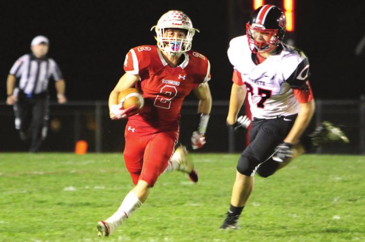 JUNIOR wide receiver Layne Cavanah gains first-down yardage on a night when he scores three touchdowns and sets up Richmond for a fourth in the team’s 62-35 playoff win against Chillicothe.