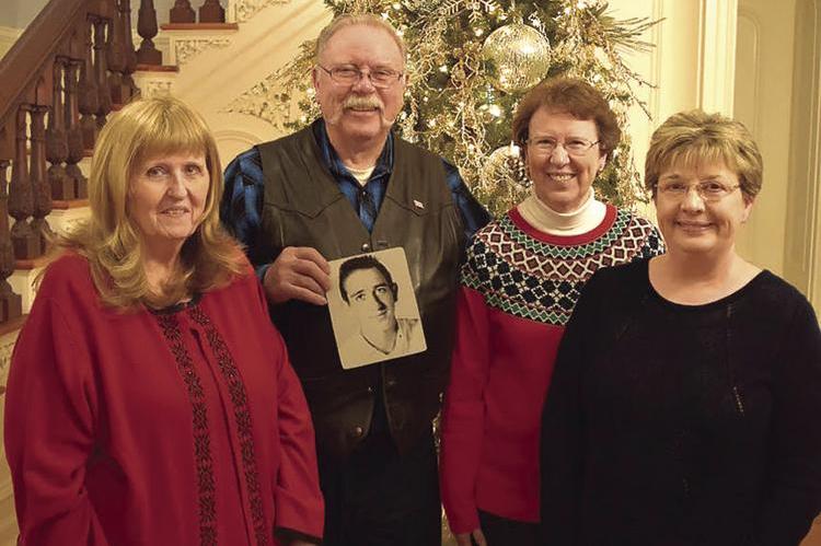 THE SHARP SIBLINGS reunite after being apart for 69 years. From left are Annette Gaiser; Dan Garnett, who holds a photo of their late brother, John; Lisa Pierce; and half-sister, Brenda Hamm. They meet at Linwood Lawn in Lexington for three days to get acquainted.