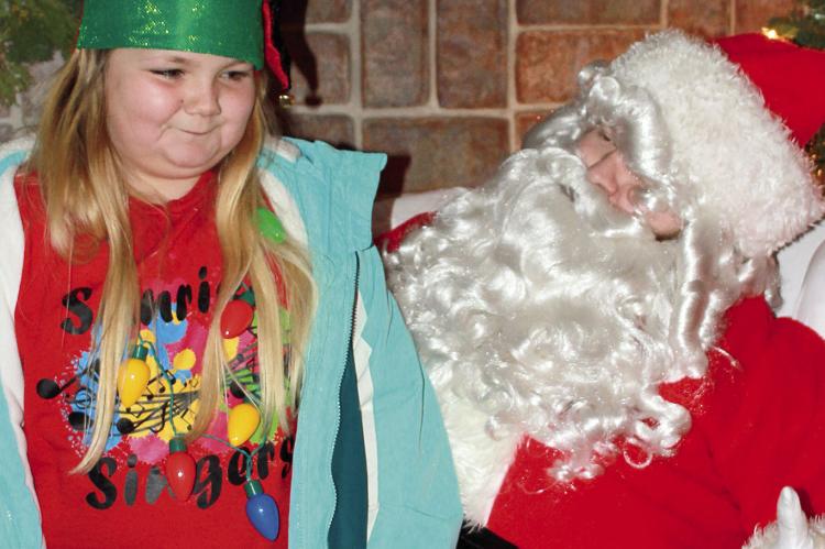 SOPHIA BALES | Staff LACI KINGERY talks with Mr. Claus about gifts this Christmas.
