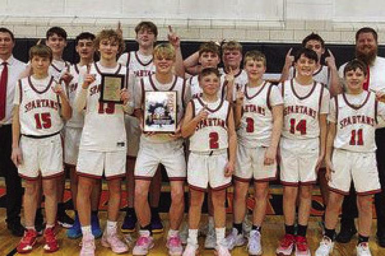 MEMBERS OF the Richmond Middle School boys basketball A team enjoy their end-of-season tournament title Jan. 25 at Knob Noster. From left are, front row, Jaxton Smith, Cale Moyer, Jack Minton, Latimer Cavanah, Carson Persell, Mason Minnick and Elan Griffin; back row, head coach Shawn Calhoun, Caige Castilleja, Chase Plonski, Dayton Palier, Kypton Burnett, Amos Farnan, Bryson Pruitt and assistant coach Bret Higgins. COURTESY OF THE RMS FACEBOOK PAGE | Submitted