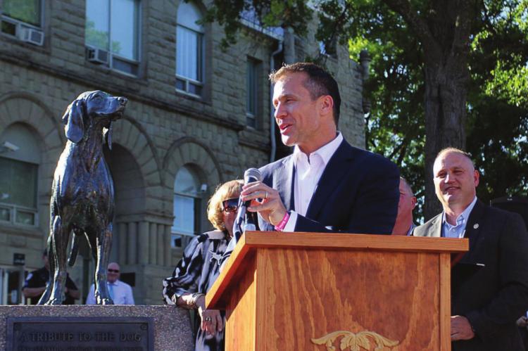 Staff THEN-GOV. Eric Greitens gives Sen. George Graham Vest’s “Eulogy to a Dog,” written in honor of Old Drum, during a bill-signing ceremony in June 2017 on the Warrensburg square in front of the dog’s statue. Behind Greitens stands Sen. Denny Hoskins, whose bill made Old Drum the official state historical dog.