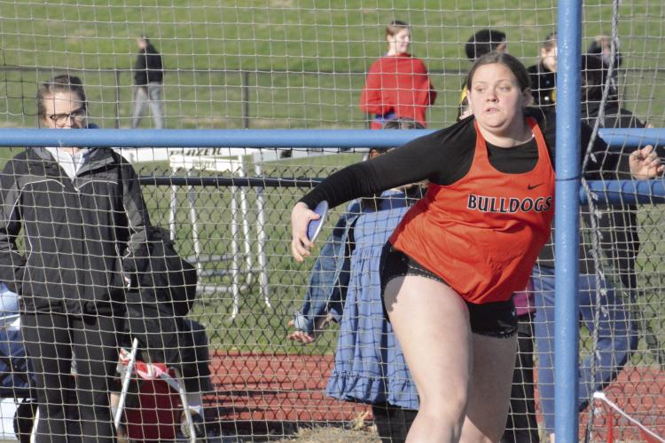 HANNAH FINLEY, a first-year high schooler at Hardin-Central, winds up to attempt a discus throw Tuesday during the Bulldogs’ season-opening meet at Lexington. SHAWN RONEY | Staff