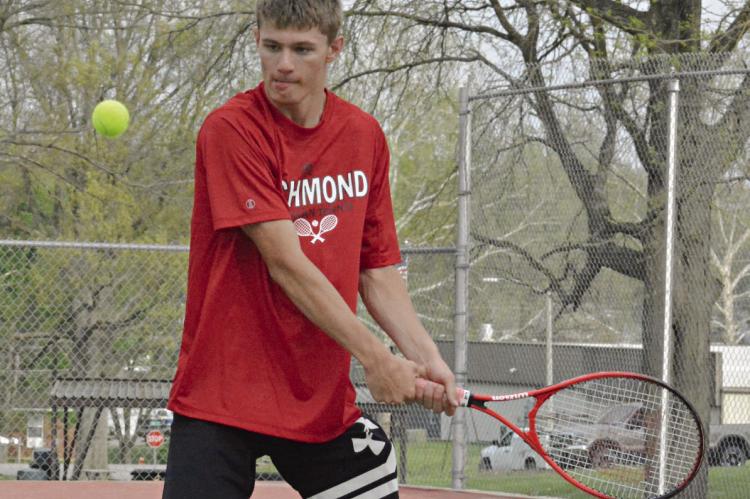 GABE BAKER is set to hit a two-hand backhand shot Monday against Excelsior Springs’ Colt Bowman Monday at Richmond. SHAWN RONEY | Staff