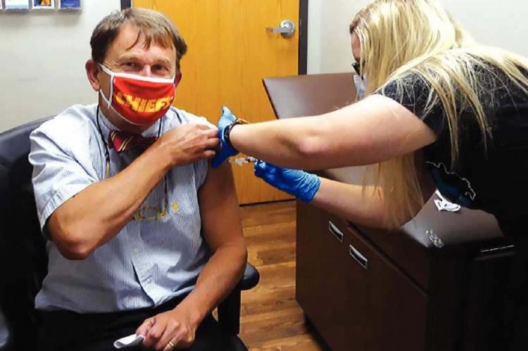 DHSS Director Randall Williams gets a flu shot, something he urges all older Missourians to get.