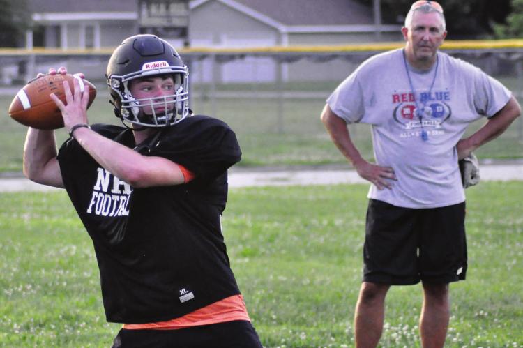 WITH LONGTIME COACH Kirk Thacker watching, Norborne Hardin-Central quarterback Brayden Schick rears back to throw a wide receiver screen pass Monday at Norborne. SHAWN RONEY | Staff