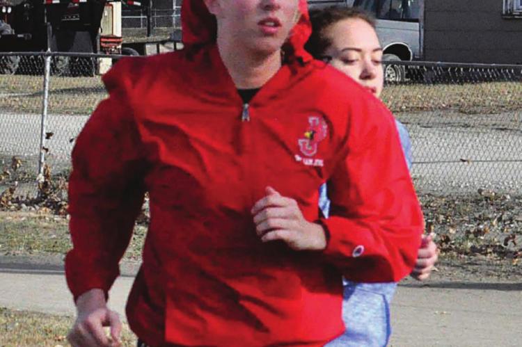 CARLY THACKER, seen training March 5 in her red windbreaker, hopes to have the chance to defend her Class 1 state girls 300-meter low hurdles title.