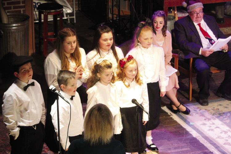 MISS OPAL’S 42nd Street Kids Choir sing in “A Christmas Carol, A Live Radio Play”, written Joe Landry. Shown in no particular order, are Abigail Garland, Anna Garland, Addison Garland, Ryker Kugler, Isabella Hendley, Paige Quick and Max Wrisinger