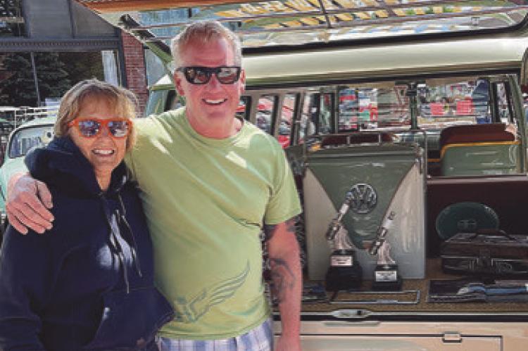 Vicki and Paul Comeau with their VW bus, which was purchased by their late son, Kyle, and restored by Vicki and Paul. They won three awards, displayed in the bus rear, at the Smithville Volkswagen show in May. LIZ JOHNSON | Submitted