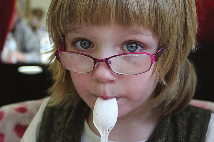 NO MORSEL of dessert on the spoon used by Sandra Huffman-Adair, 7, goes to waste.