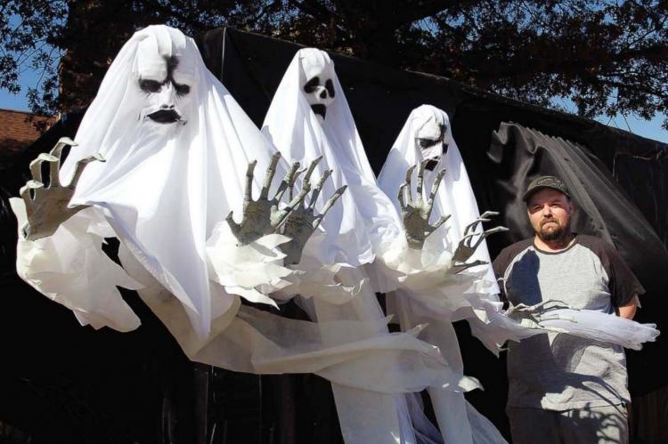 THREE INTENSE GHOSTS and Kenny Thompson stand ready on Halloween to greet trick-or-treaters. J.C. VENTIMIGLIA | Staff