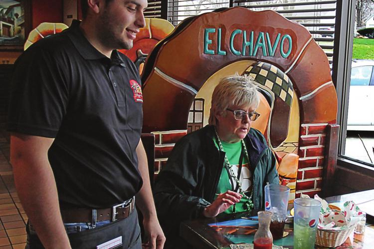 AT TEQUILA JALISCO Mexican Restaurant in Richmond, the doors last week remain open and Heraldo Hacentio waits on a customer, Janis Kincaid, Excelsior Springs. On Tuesday, the commission ordered restaurants to close their doors to walk-in customers. J.C. VENTIMIGLIA | Staff