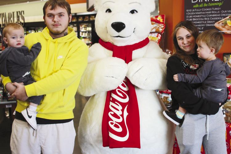 Kaison, CJ, Delia and Arrow Barber enjoy the festivities at a local food store in Richmond. The Coca-Cola Polar Bear made its appearance in Ray County along with Santa Claus and the Grinch. SOPHIA BALES | Staff