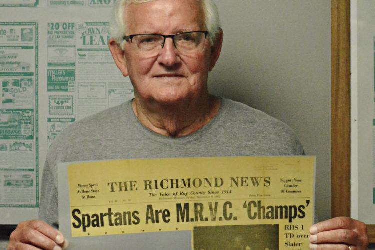 RICHMOND HIGH SCHOOL alumnus Norman Bowman displays a 1962 newspaper clipping about the Spartans’ conference title run in varsity football. SHAWN RONEY | Staff