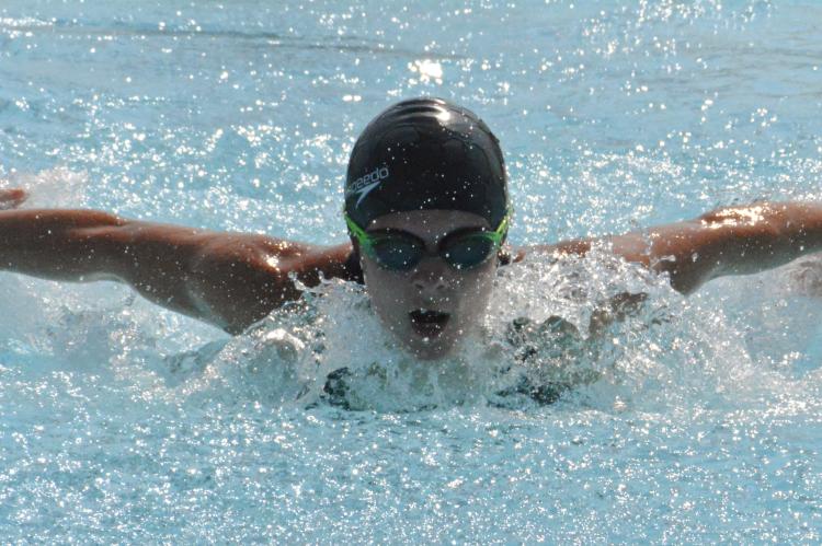 SHAWN RONEY | Staff GRACE BOZARTH displays her butterfly stroke skills while racing for the Dolphin Swim Team in conference competition July 22 at Southview Pool.
