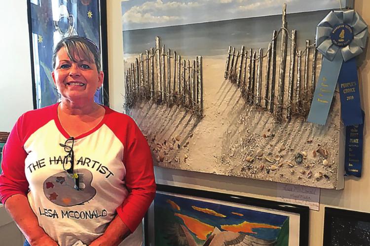 THE 2019 People’s Choice award winner during the Ray County Community Arts Association’s Annual Fine Arts and Photography Show, Lesa McDonald, shows off her painting.