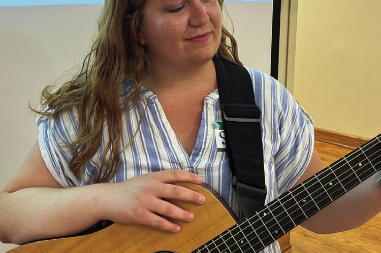 Ray County Special Needs Service Music Therapist Sydney Winders tunes her guitar before starting the first CAP Community Choir 16-week event. SOPHIA BALES | Staff