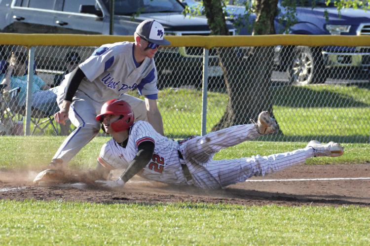 CONNER RODENDBERG hits the dirt in legging out a triple for the Spartans Monday during Richmond’s 7-0 win over West Platte at Southview Park. His extra-base hit sparks a four-run sixth inning. SHAWN RONEY | Staff