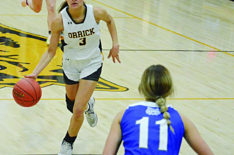 JUNIOR ANELA FLETCHER pushes the pace for Orrick as Southwest of Livingston County junior Leanna Smith awaits her during the first half of varsity girls basketball action Nov. 30 in the Orrick High School gym. SHAWN RONEY | Staff
