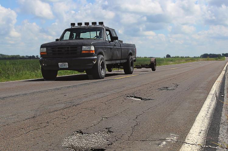 THIS DAMAGE is visible on Route J in southern Ray County. The surface, like surfaces on roads across the Northland, suffers from numerous cracks and potholes, with some of the wear being due to blowups, Missouri Department of Transportation information states. J.C. VENTIMIGLIA | Staff